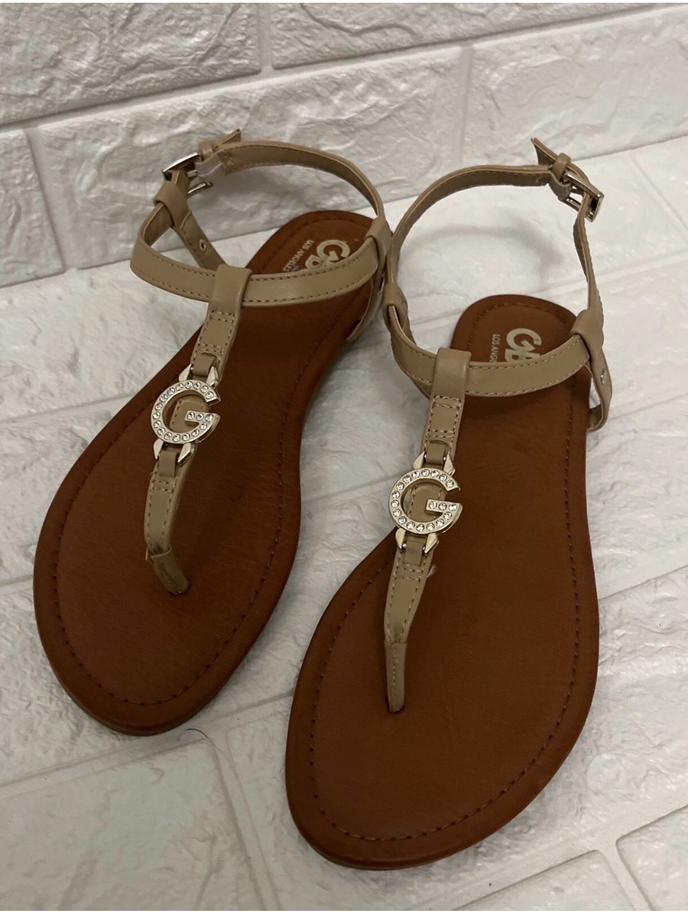 G by Guess Nude T-Strap Sandals with Gold Logo Accent